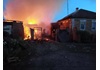 ロシア西部ベルゴロド州で攻撃を受け炎上する家屋＝６月（ロイター＝共同）