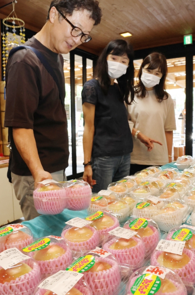 手に取って品定めをする買い物客＝豊後大野市清川町砂田の道の駅きよかわ