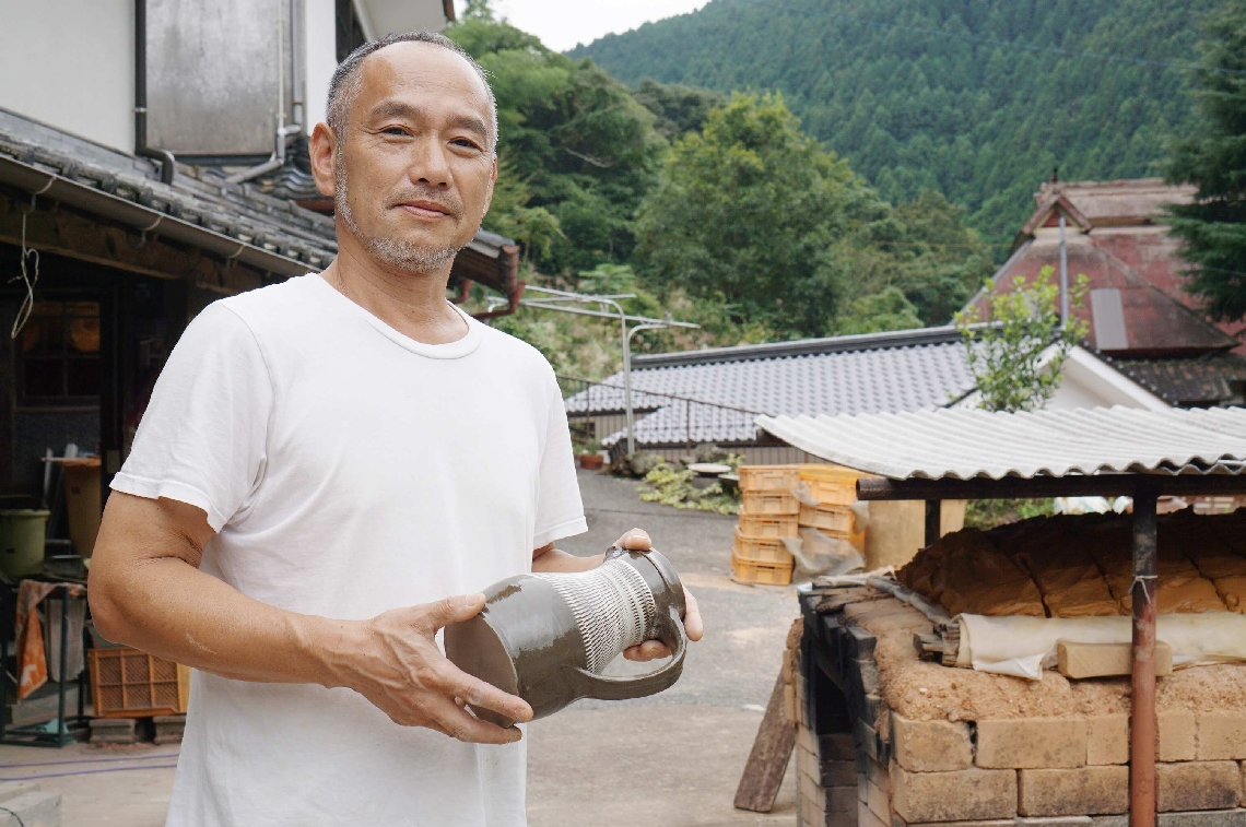 ５年ぶりの民陶祭に出品する水差しを手にする坂本浩二副理事長＝日田市源栄町の小鹿田焼の里