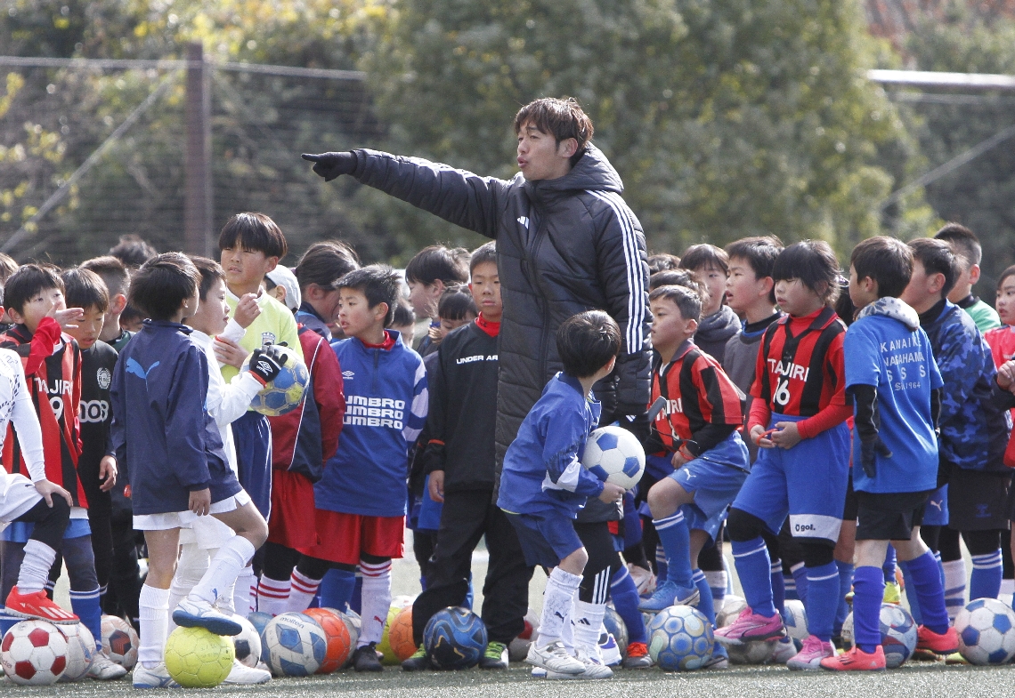 サッカークリニックで子どもたちに指導する清武（中央）