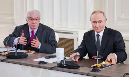ロシアのプーチン大統領（右）と世界主要通信社の代表らとの会見で司会を務めるタス通信のグスマン第１副社長＝６月、サンクトペテルブルク（タス＝共同）