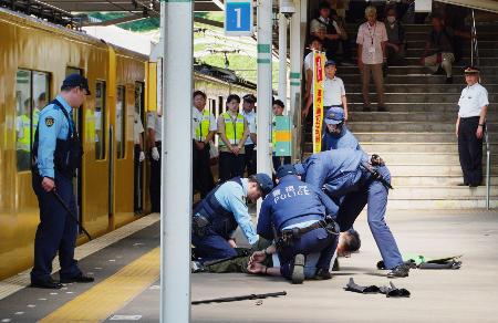 警視庁東村山署が実施した訓練で、犯人役を制圧する警察官ら＝２９日午前、東京都東村山市の西武園駅