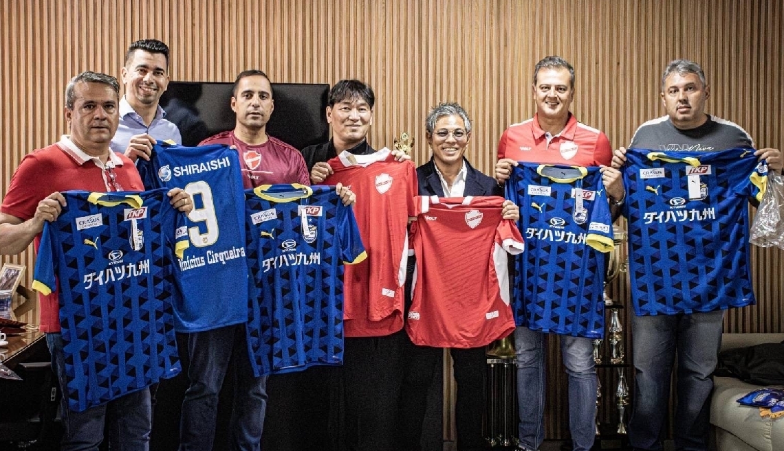 調印後に記念撮影をする大分ＦＣの小沢社長（左から４人目）とヴィラ・ノヴァＦＣのヒューゴ代表（同３人目）ら＝ヴィラ・ノヴァＦＣⓒ大分ＦＣ
