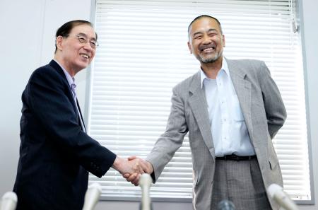福井中３殺害事件の再審無罪が確定し、記者会見後に吉村悟弁護団長（左）と握手する前川彰司さん＝１日午後、福井市