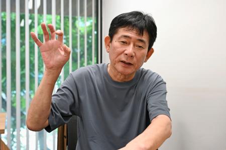 ８日、バンコクで取材に応じる井本勝幸さん（共同）