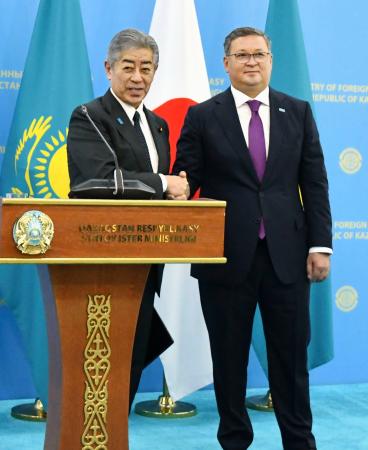 カザフスタンのヌルトレウ副首相兼外相（右）と握手する岩屋外相＝２５日、アスタナ（共同）
