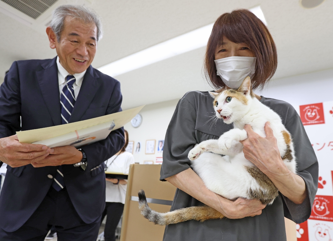 動物愛護週間（２０～２６日）に合わせて開かれた親子ふれあい動物フェスタで、長寿の犬と猫が表彰された。２１歳の飼い猫「あび」は人間でいうと１００歳を超えるおばあちゃん猫。飼い主と一緒に賞状を受け取り「ニャー」と感謝の言葉を述べた＝２３日、大分市廻栖野のおおいた動物愛護センター