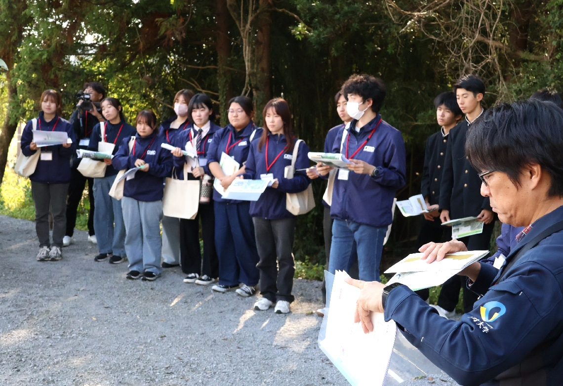 八坂川の氾濫による被害の様子を聞く学生と生徒