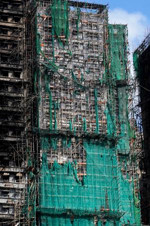 大規模火災が起きた香港の高層住宅群の外壁に残る防護ネット＝２９日（共同）