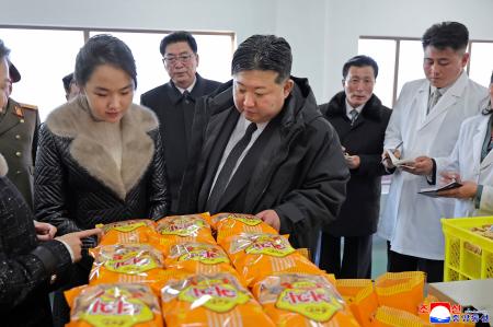 北朝鮮の東部咸鏡南道新浦の工場を視察する金正恩朝鮮労働党総書記（手前右）と娘（同左）＝１９日（朝鮮中央通信＝共同）