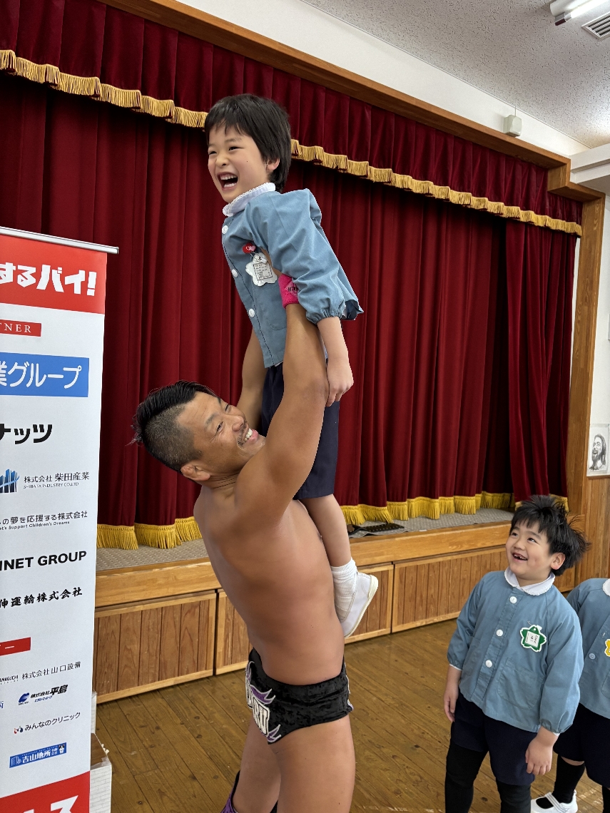 園児を持ち上げる佐々木日田丸選手