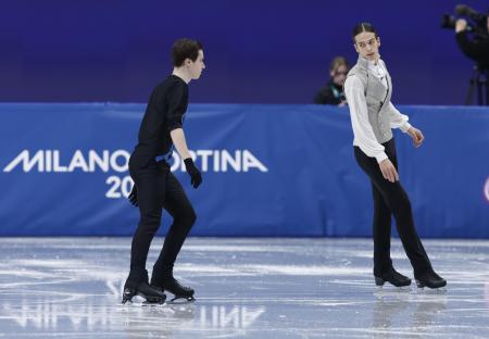 フィギュアスケート男子フリーの演技を前に、ウオームアップするロシア出身のＡＩＮのピョートル・グメニク（右）とウクライナのキリロ・マルサク＝１３日、イタリア・ミラノ（共同）