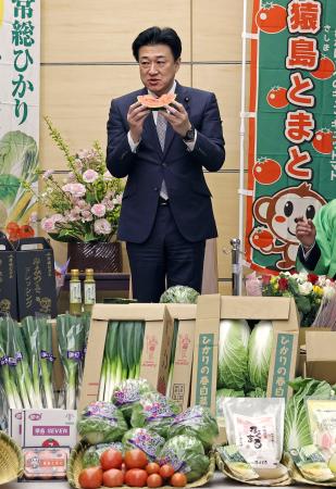 茨城県の農業関係者らから贈られた「こだますいか」を堪能する木原官房長官＝７日午前、首相官邸