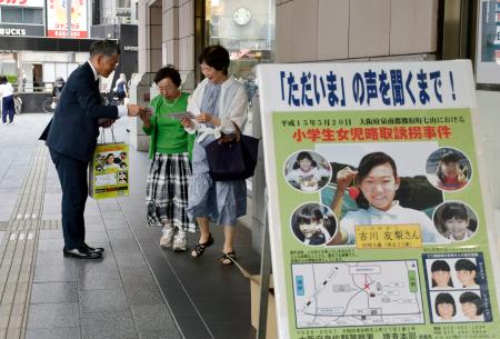 吉川友梨さんの情報提供を求める大阪府警の捜査員（左）＝２０日午後、大阪市中央区
