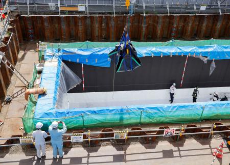 クレーンで最終処分施設に搬入される廃棄物＝２６日午前、大阪府豊能町