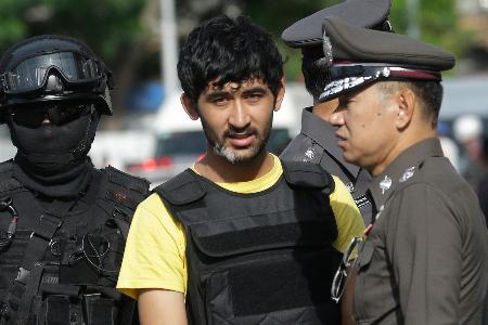 警察官に付き添われるユスフ・マイライリ被告（中央）＝２０１５年９月、タイ首都バンコク（ＡＰ＝共同）