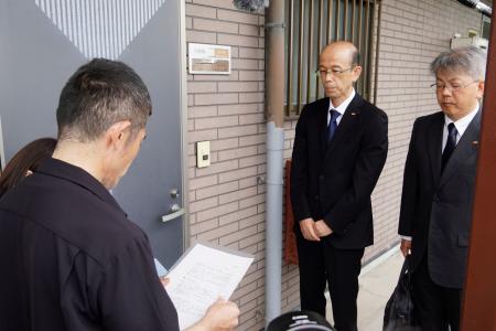 松岡一輝さんの遺族（手前）に第三者委員会を設置する方針を報告する四国電力送配電の幹部＝１８日午前、徳島県石井町（住宅の部屋番号にぼかしを入れています）
