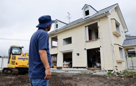 地震発生から２カ月となり、熊本県甲佐町の住宅で始まった公費解体作業を見守る住人の園田恵二さん＝２８日午後